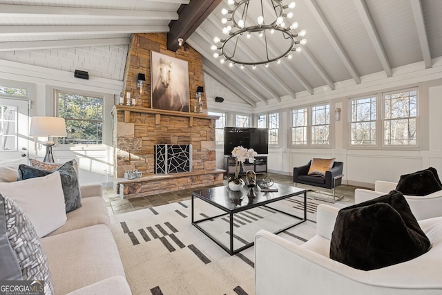 living room with lofted ceiling with beams, a notable chandelier, a fireplace, and a decorative wall