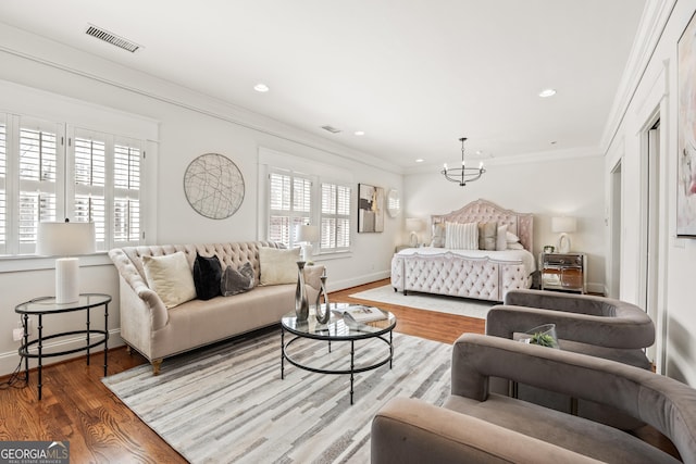 bedroom featuring wood finished floors, visible vents, recessed lighting, crown molding, and a notable chandelier