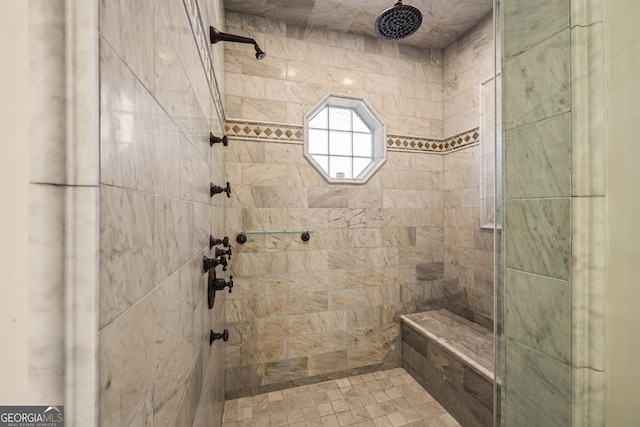 full bathroom with a tile shower