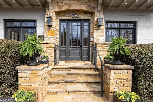 view of exterior entry with stone siding