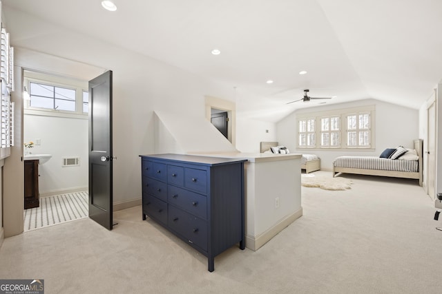 bedroom with multiple windows, lofted ceiling, and light colored carpet