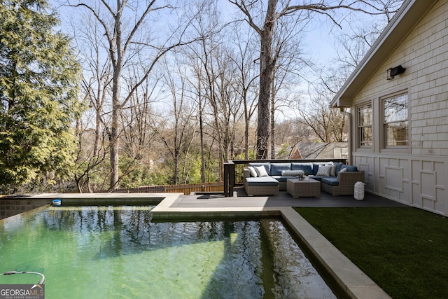 wooden terrace featuring a fenced in pool and an outdoor hangout area