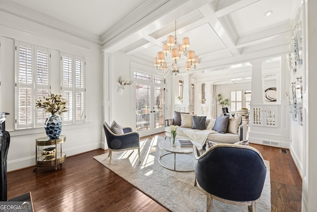 living area featuring wood finished floors, visible vents, coffered ceiling, french doors, and crown molding