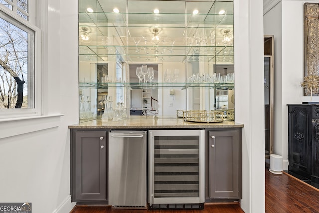 bar with wine cooler, dark wood-style floors, a dry bar, and baseboards