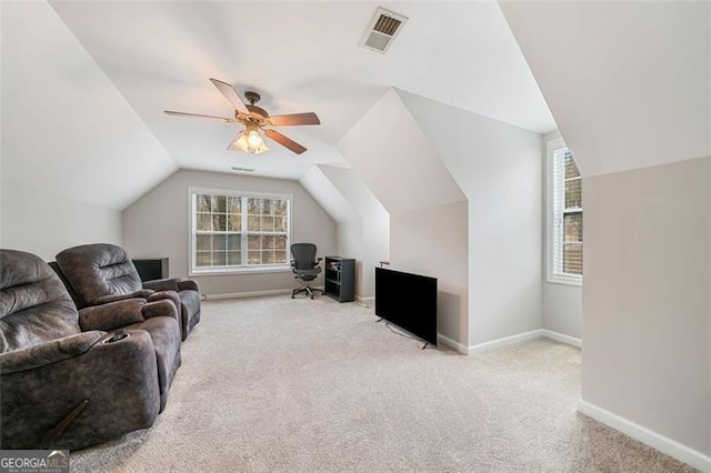 living area with visible vents, a ceiling fan, carpet floors, baseboards, and vaulted ceiling