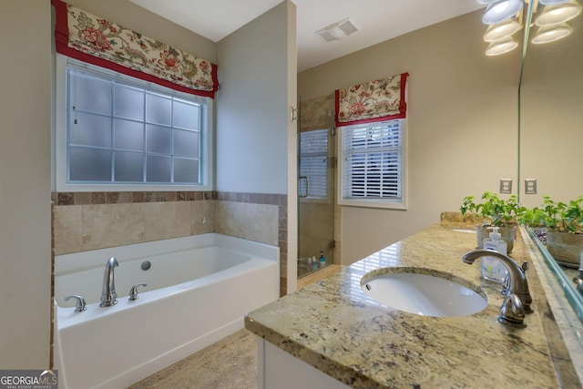 bathroom featuring visible vents, a sink, a shower with door, double vanity, and a bath