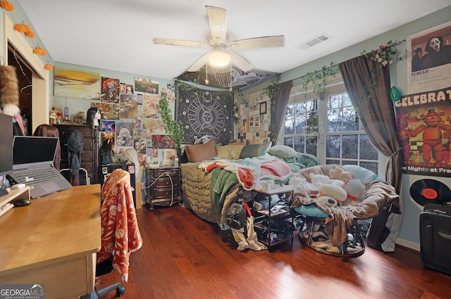 bedroom featuring visible vents, wood-type flooring, and ceiling fan