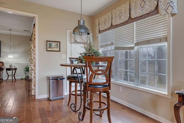 dining space with baseboards and wood-type flooring