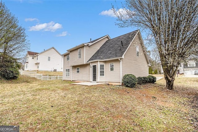 rear view of property with a patio area, a lawn, and fence