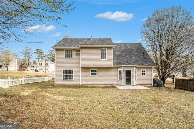 back of house featuring a yard, a patio, and fence