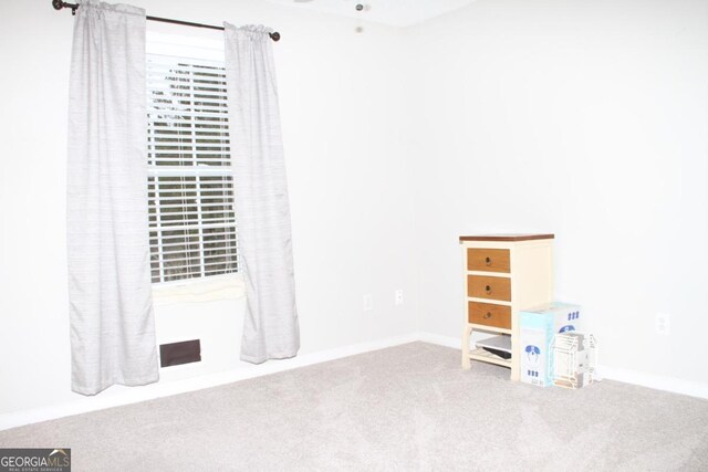 interior space with carpet flooring and a ceiling fan