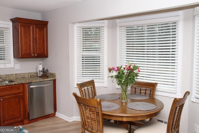 dining room featuring visible vents, baseboards, and light wood-style floors