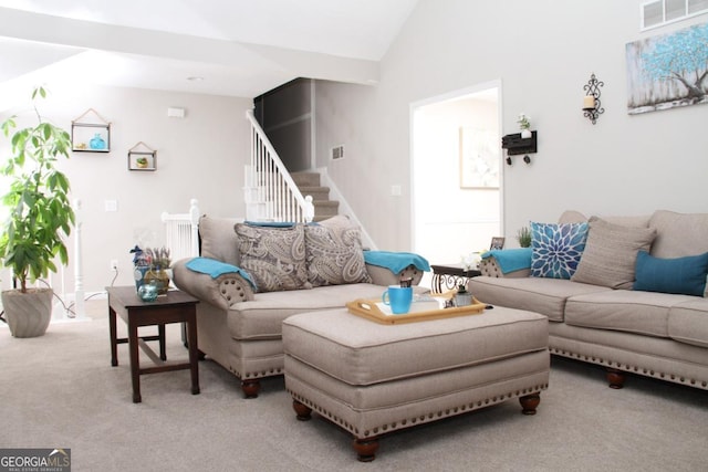 living area with visible vents, light carpet, lofted ceiling, and stairway