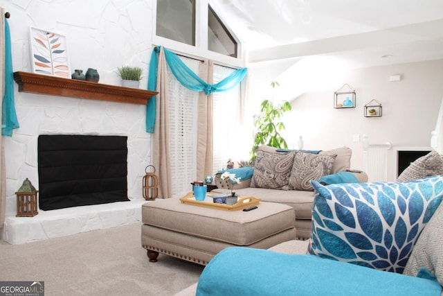 living area featuring a fireplace and carpet floors