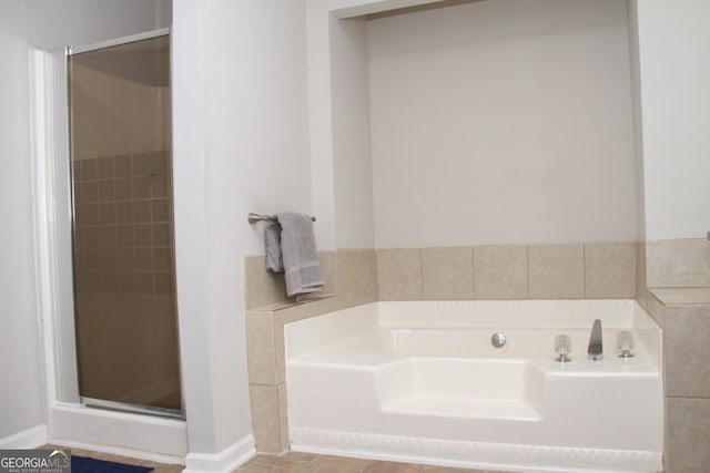 bathroom featuring a bath and a stall shower