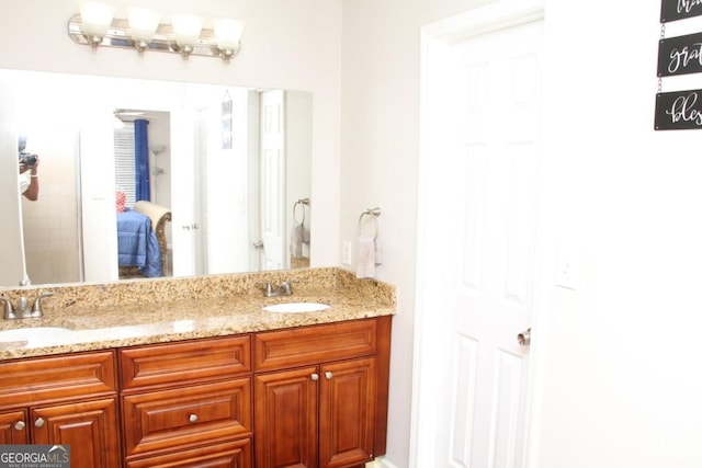 bathroom featuring a sink and double vanity