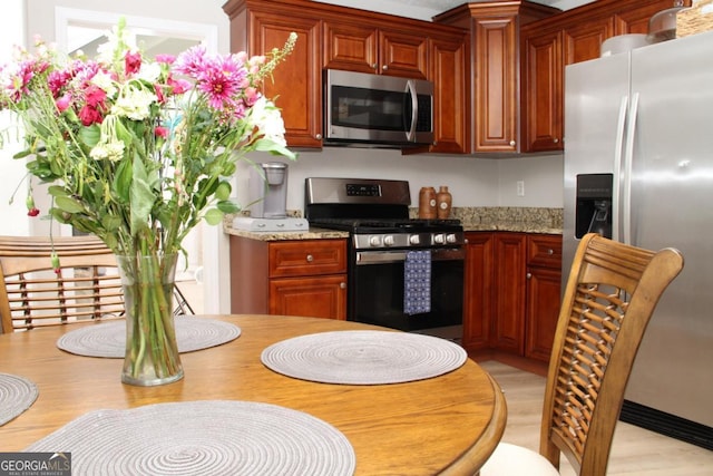 kitchen with stainless steel appliances and light wood-style flooring