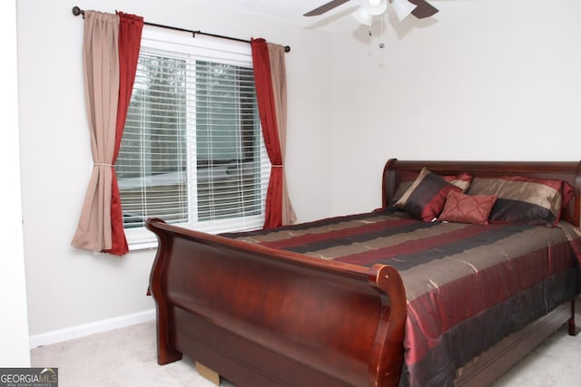 carpeted bedroom featuring baseboards and a ceiling fan