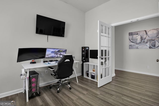 home office featuring baseboards and wood finished floors