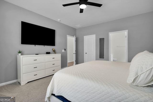 bedroom featuring connected bathroom, a ceiling fan, baseboards, and light carpet