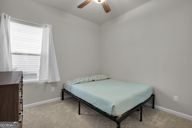 bedroom featuring multiple windows, baseboards, and carpet floors