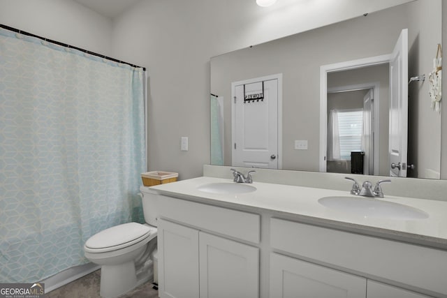 full bathroom featuring a shower with curtain, double vanity, toilet, and a sink