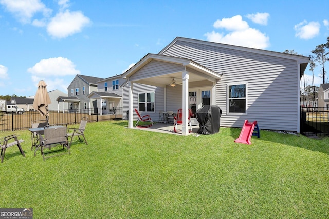 back of house with a patio area, a lawn, fence, and ceiling fan