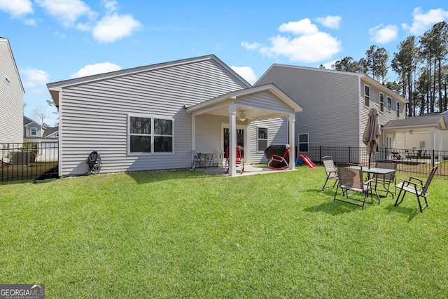 back of house with a patio, a lawn, a fenced backyard, and a ceiling fan