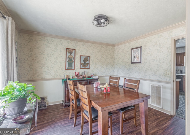 dining area with visible vents, wainscoting, and wallpapered walls