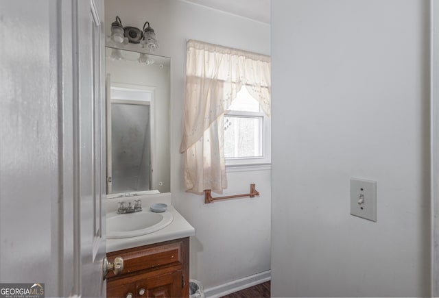 bathroom with vanity and baseboards