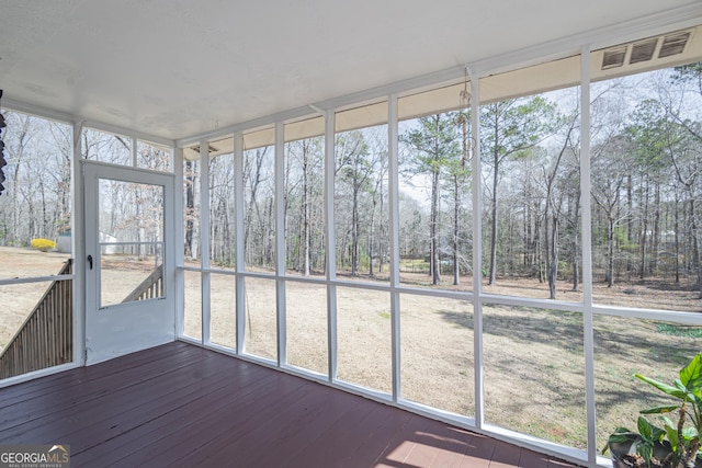 unfurnished sunroom with visible vents