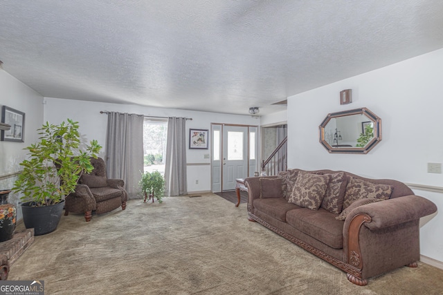 carpeted living area with a textured ceiling