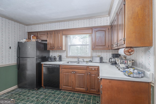 kitchen featuring wallpapered walls, black appliances, light countertops, and a sink