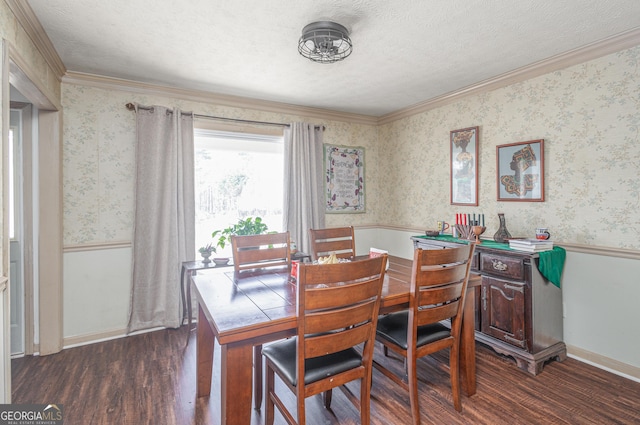 dining space featuring wallpapered walls, dark wood finished floors, a wainscoted wall, and a textured ceiling