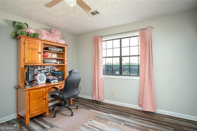 office space with dark wood finished floors, visible vents, a textured ceiling, and baseboards