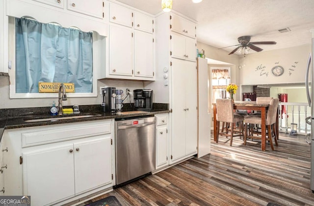 kitchen with a sink, ceiling fan, dishwasher, white cabinets, and dark wood-style flooring