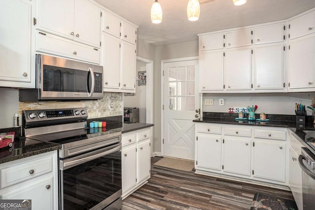 kitchen featuring dark wood finished floors, decorative backsplash, appliances with stainless steel finishes, a textured ceiling, and white cabinetry