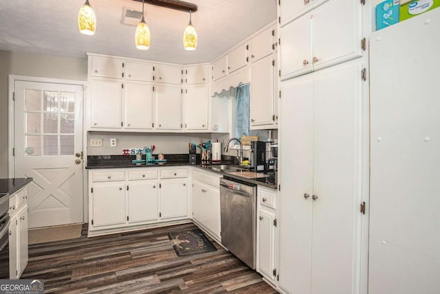 kitchen with dark countertops, white cabinets, dishwasher, and a sink