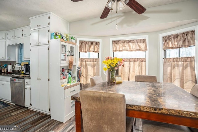 dining room with ceiling fan, dark wood-type flooring, and a textured ceiling