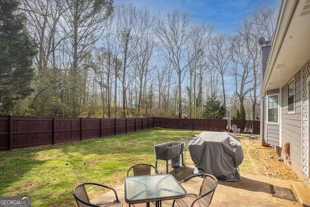 view of yard with outdoor dining space, a patio, and a fenced backyard