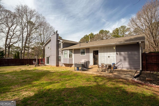 back of house with a lawn, a patio, and fence