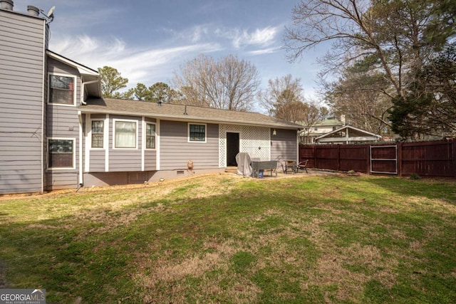 back of property featuring a lawn, a patio, and fence