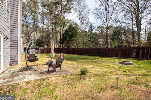 view of yard featuring a patio area, an outdoor fire pit, and a fenced backyard