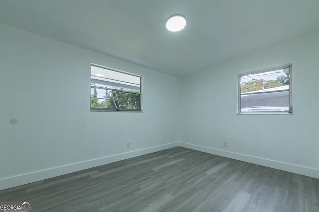 empty room with baseboards and wood finished floors