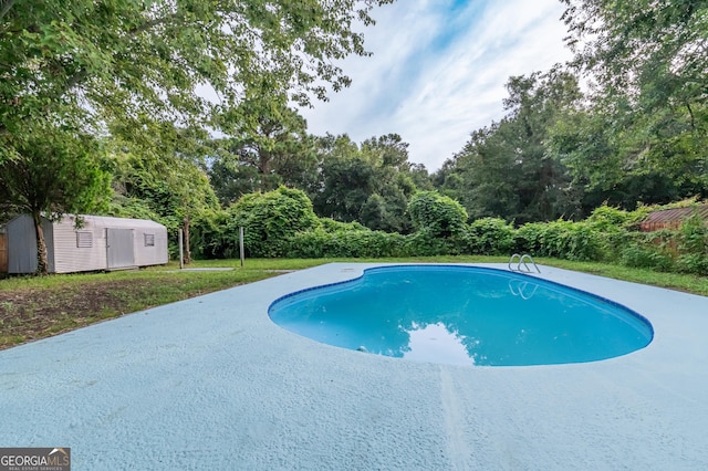 pool with a storage shed and an outbuilding