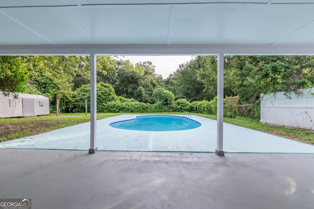 view of pool featuring a patio area, a fenced in pool, and fence