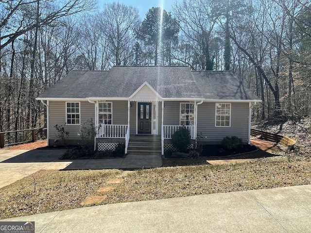 view of front of home featuring a porch and roof with shingles