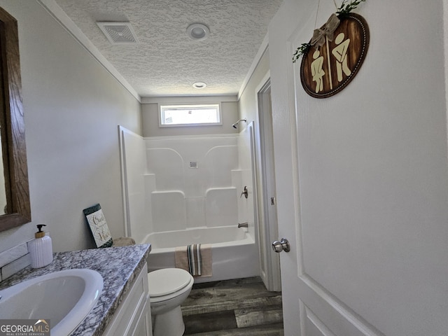 full bath featuring vanity, wood finished floors, visible vents, a textured ceiling, and toilet