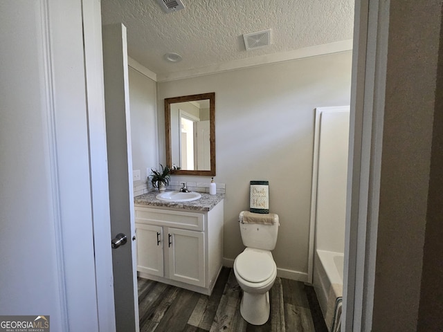 full bath featuring vanity, toilet, wood finished floors, and visible vents