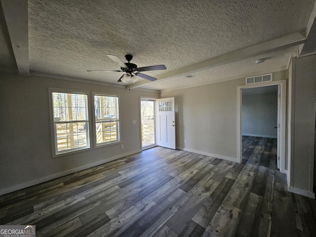 spare room featuring visible vents, a ceiling fan, a textured ceiling, dark wood finished floors, and baseboards